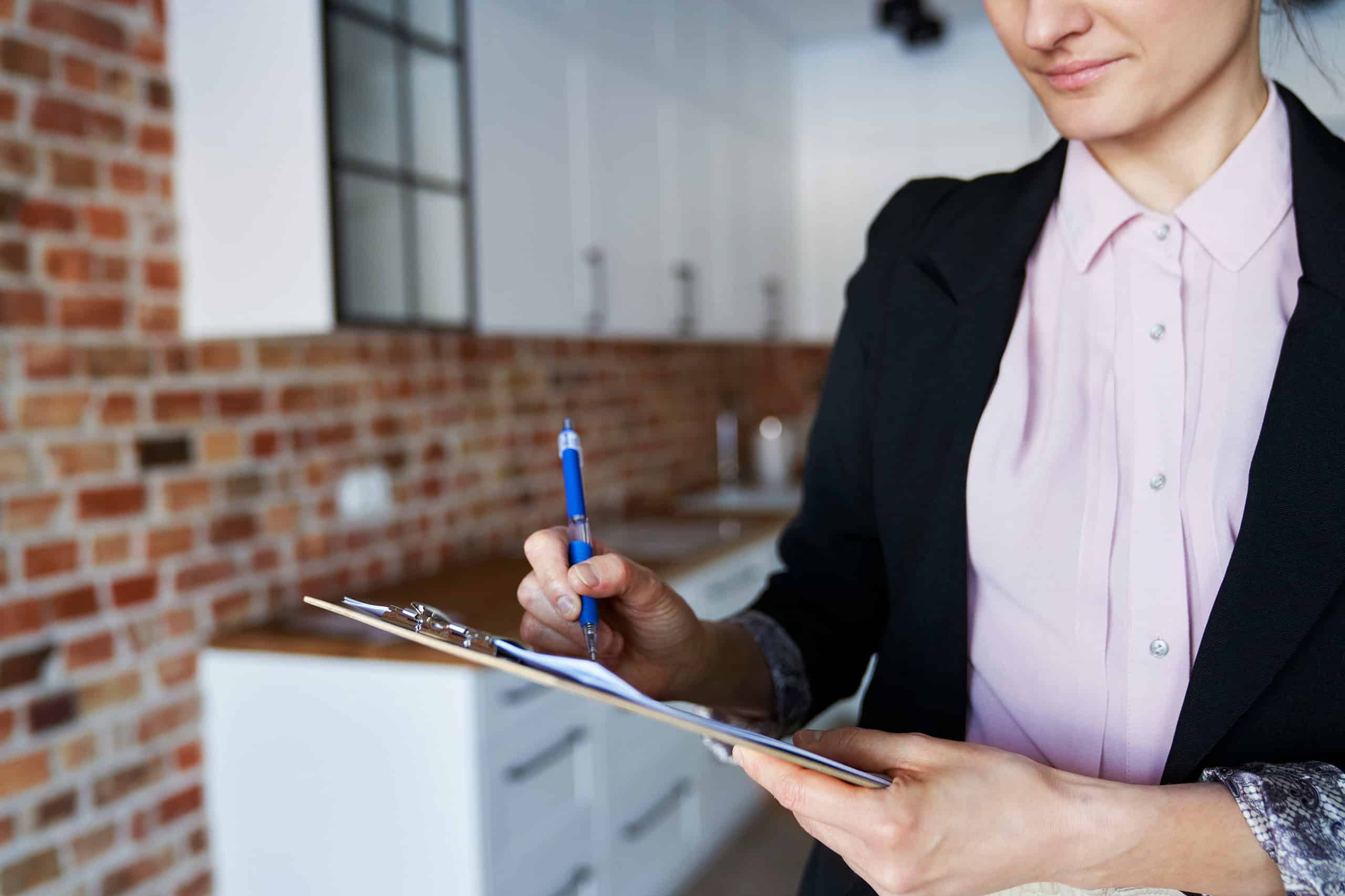 DC Nanny Agency recruiter reviewing a placement checklist and vetting nanny applications on a clipboard
