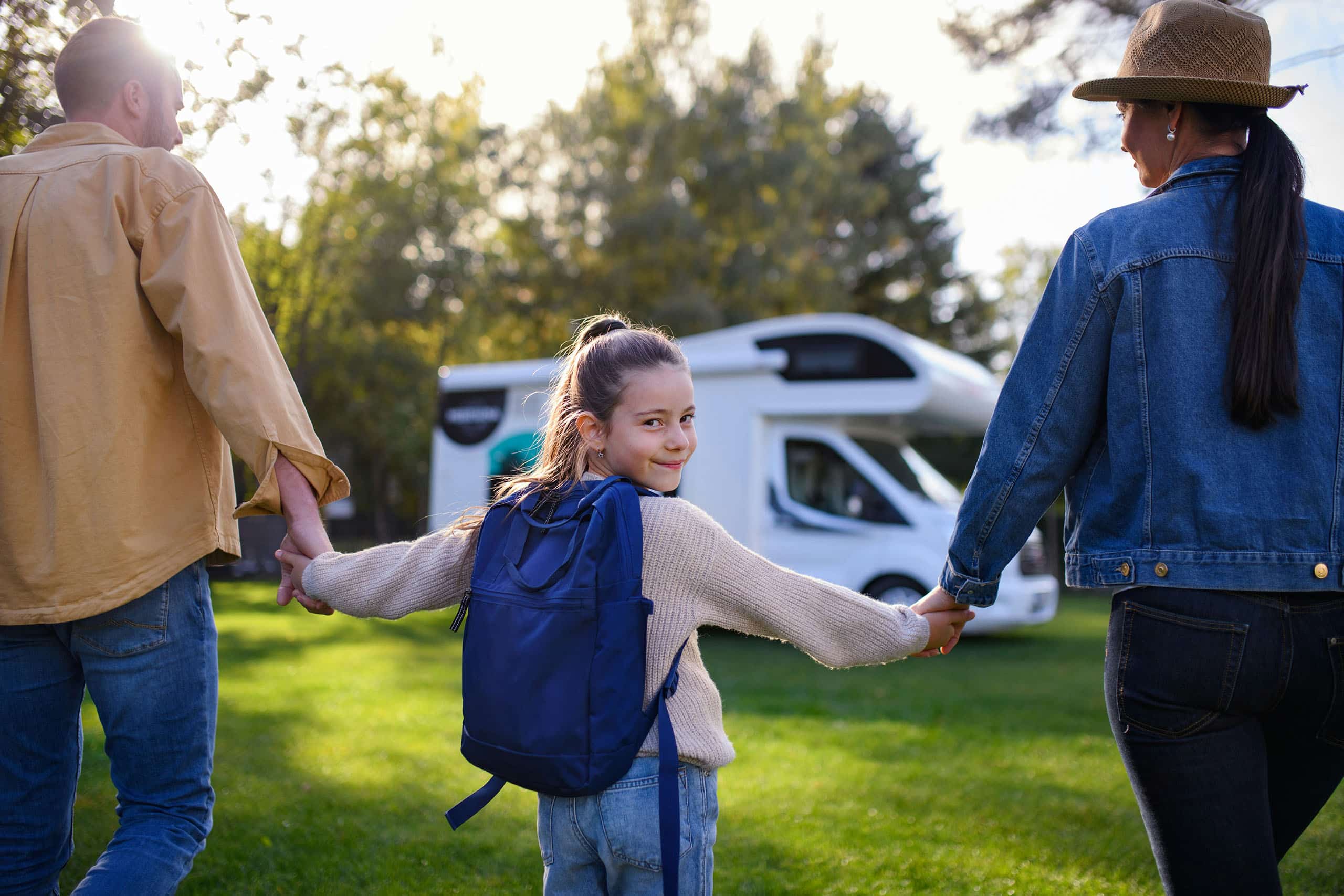 Family holding hands and walking together outdoors supported by DC Nanny Agency placement services