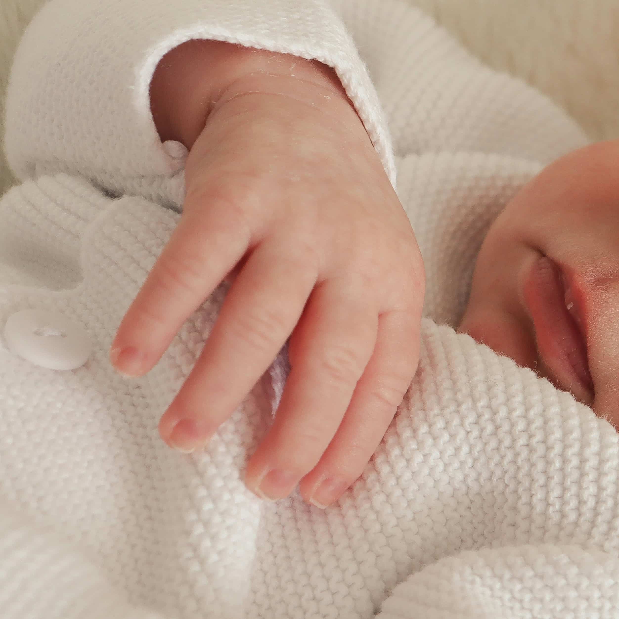 Newborn baby resting comfortably, representing newborn care specialist and night nanny services in Washington DC